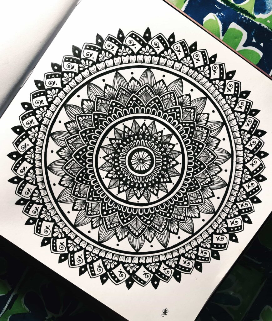 An intricate monochromatic mandala artwork with circular patterns.